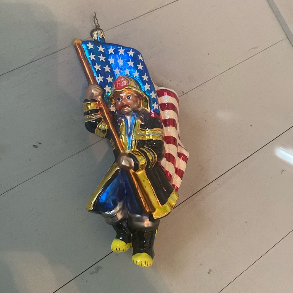 Christopher Radko Fireman holding American flag ornament